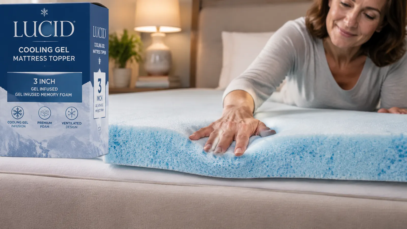 Hand pressing down on a gel-infused memory foam mattress topper, showing the cooling texture and layer thickness