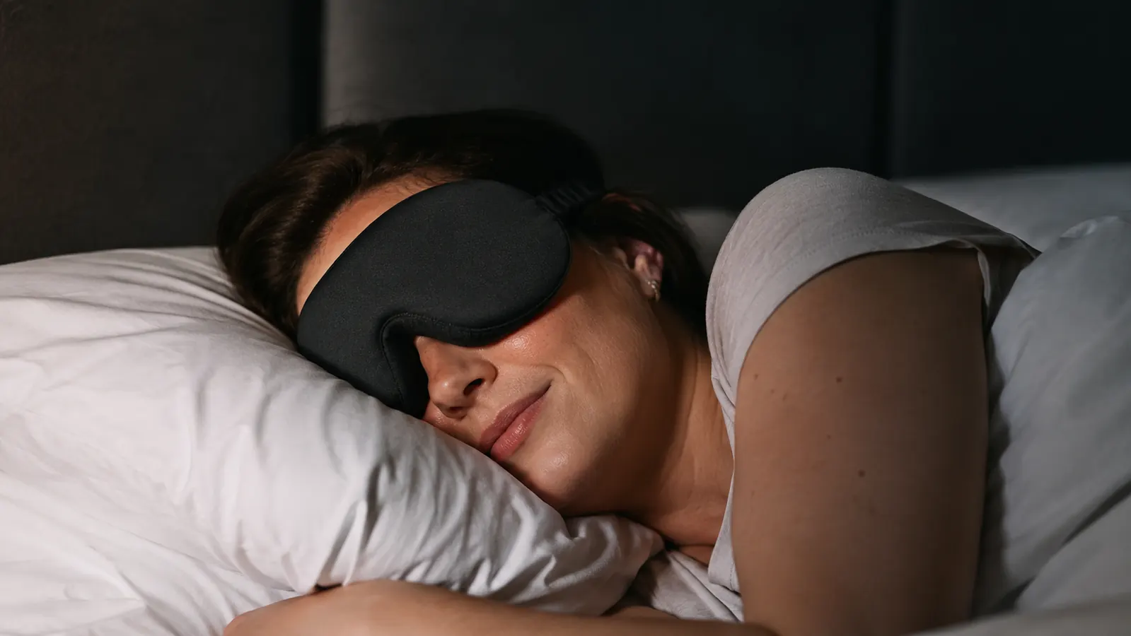 A woman sleeping on her side wearing a 3D sleep mask with no pressure on her eyes